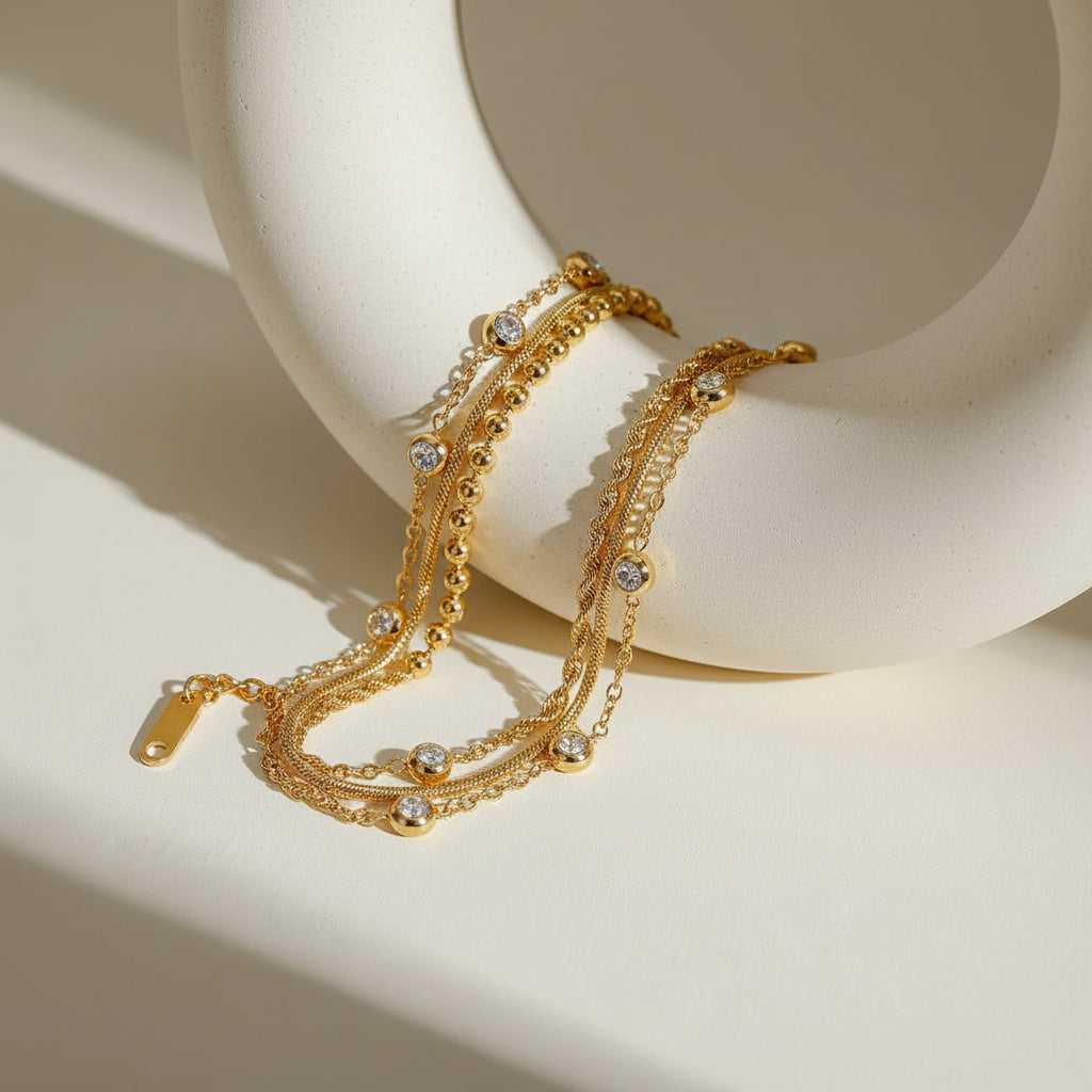 Gold bracelet with intricate design on a light surface