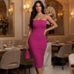 Main Character Strapless Midi Dress in bold magenta with a body-contouring silhouette on a model in a luxe dining room.