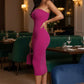 Main Character Strapless Midi Dress in bold magenta on a model in a restaurant, form-fitting silhouette.