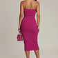 Main Character Strapless Midi Dress in magenta on model, back view with body-con silhouette, pink handbag and heels.