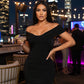 Black off-shoulder dress on a plain background