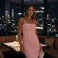 After Dark Strapless Midi Dress in pink with ribbed stretch fabric and side slit, model in city nightlife setting.